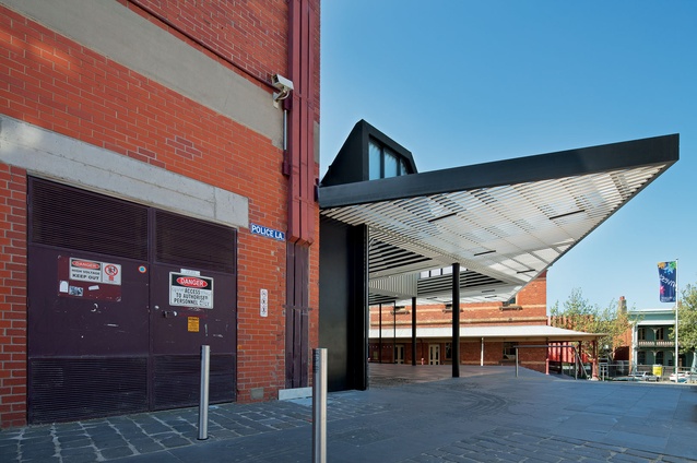 The annexe sits in a back-of-house context, facing an underused plaza.