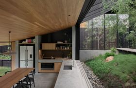 The kitchen and dining area can be opened on two sides to garden and courtyard.