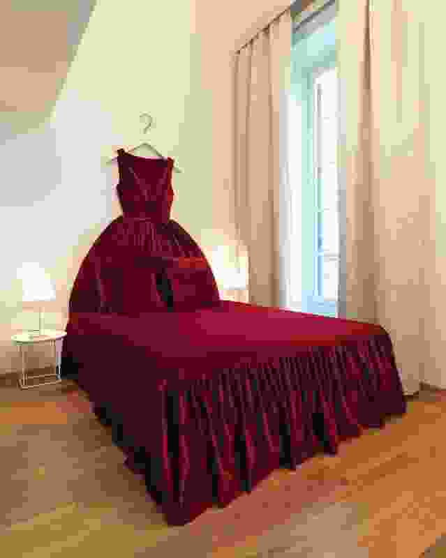 A red velvet ballgown makes a luxurious bedhead.