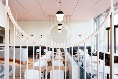 The timber screen was used to zone the dining space. The exact placement of the timber arch aligns with the two-toned circle on the back wall.