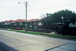 By the 1930s the decoration is gone but the same plans, with small windows, remain, as do the dark bricks and tiles and the poor orientations. The verandah has been reduced to a porch, facing the street, of course. Image: Tone Wheeler