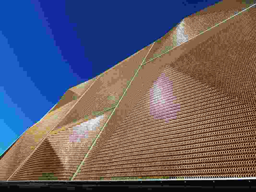 Bronze pyramids to the facade screen glow in direct sunlight: the mesh provides good visibility to those working inside.