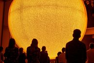  Presence  (2025), installation view, Gallery of Modern Art, Brisbane. A fake sun looms over visitors, highlighting humanity's dependence on certain elemental materials.