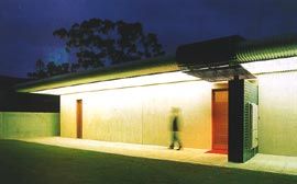 Night lighting transforms the street face into a strange, abstracted object.