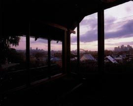 Looking north-east over Balmain backyards to the city, framed by the broad brim of the roof in the upper level main bedroom.