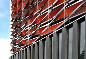 The new BLaKC by FJMT sports a facade of red aluminium sunscreens.