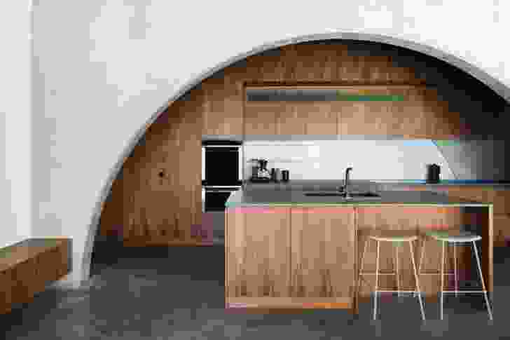 The heaviness of the concrete building is offset by the form of the arches and the timber joinery.