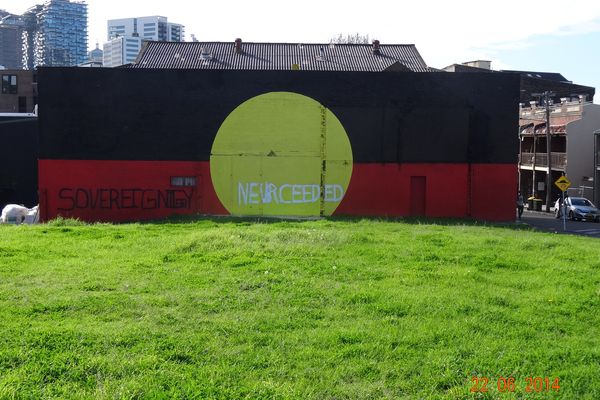 An inscription over the Aboriginal flag on the back of a gym in Redfern, 22 June 2014. 