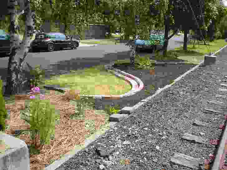 The garden in about 2008, soon after work began on it, showing legacy trees and weedy lawn, with new soil in edged beds and some early plantings.