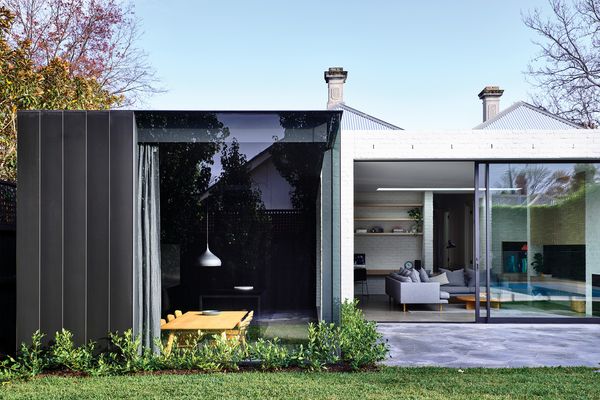 The split level within the extension is reinforced through a bold shift in colour and materials.