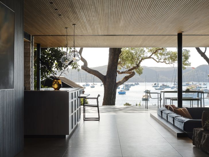 Heading toward the back of the house, you are met with an open-plan living, dining and kitchen area, synonymous with modernist design principles.