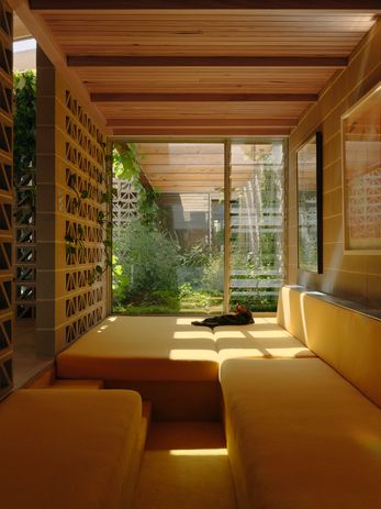 A sunken yellow daybed is a sun-bathed place for retreat.