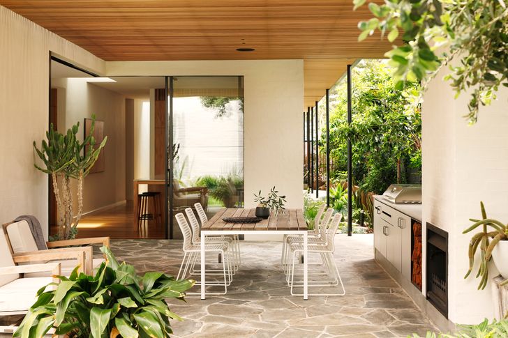 A new covered outdoor living area connects to the kitchen and family room.