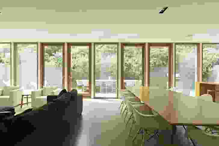 The north-facing living space is lined with full-height windows.