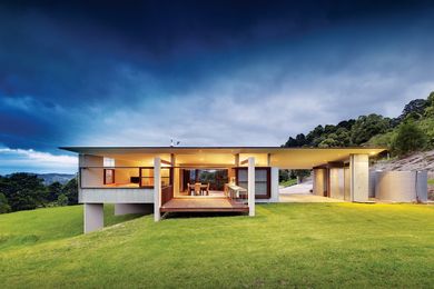 The pavilion is elevated off the ground plane on concrete fins.