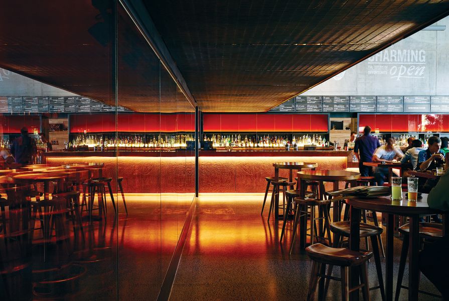 Amber-toned glass is used as feature walling to the keg room, and as lighting panel backdrops in the bar areas.