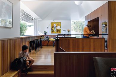The richness of the kitchen’s spotted gum finishes makes it a warm, inviting space for the everyday activities of family life. Artwork: Jason Wing.
