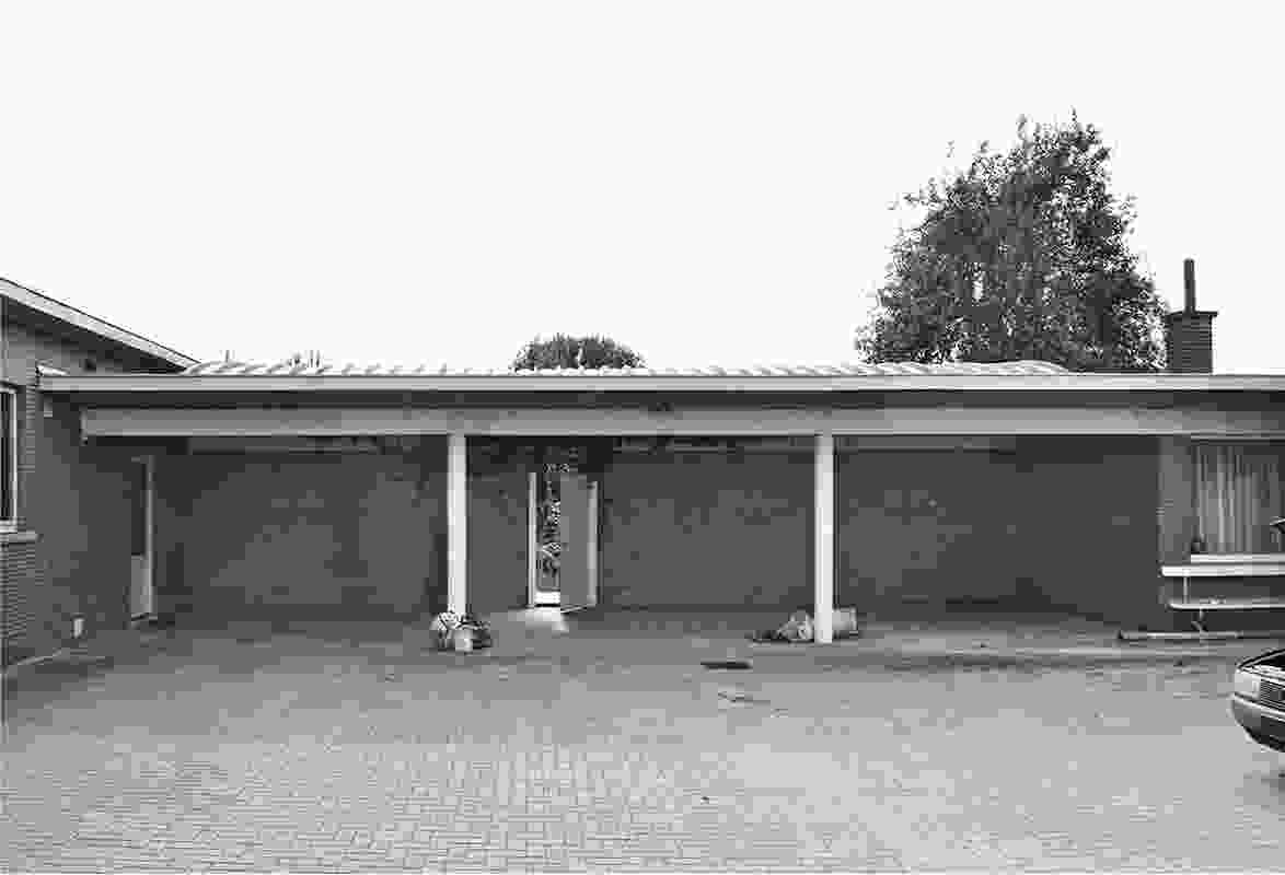 The existing carport before the conversion, a concrete frame with a brick wall to the rear.