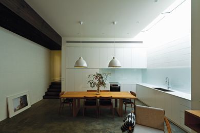 A lowered “bulkhead” corridor ceiling emphasizes the transition from the original house.