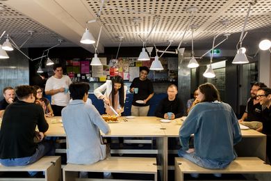 Staff and students share morning tea together in the University of Queensland's School of Architecture, recently renovated by m3architecture.