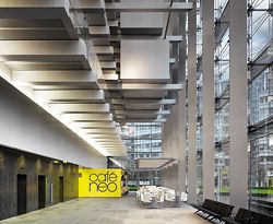 Looking along the length of the lobby, which occupies the lower part of the full-height atrium. Photographer Daniel Hopkinson.
