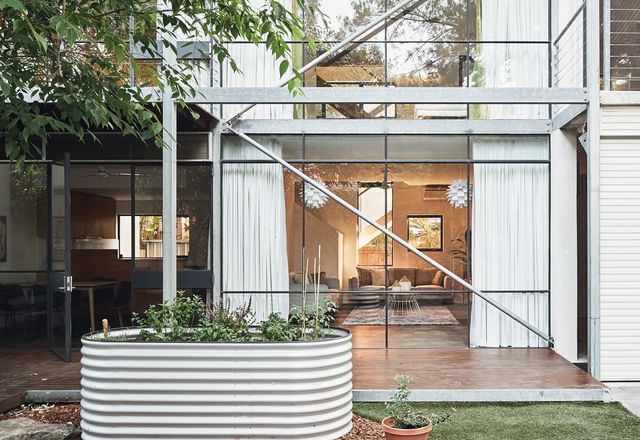 Hidden behind a heritage cottage, the house presents a dramatic glass facade to the north-facing courtyard.