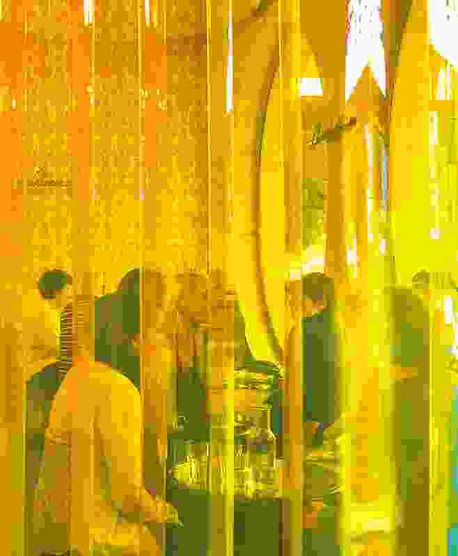 A wall of plastic amber curtain, the type seen in old souvlaki shops, is used to zone spaces.