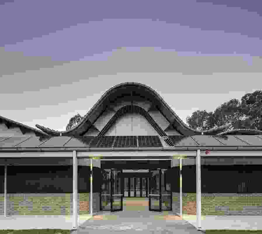 The undulating roof of Woodcroft Neighbourhood Centre by Carter Williamson Architects arches over the central foyer.