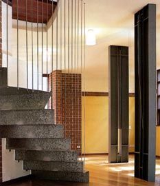 The supple white spaces and twinned columns of an apartment interior.