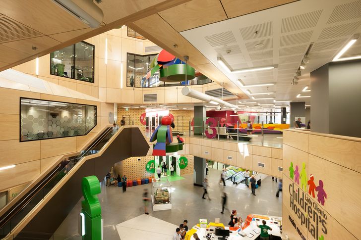 Two atriums, one at each end of the hospital, serve as vertical cores and provide visual links between floors. Artwork by Helga Groves animates the timber-veneer surfaces adjacent to the lift lobbies.