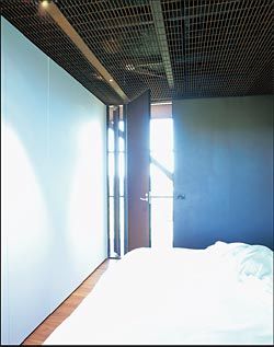 The more enclosed space of one of the bedrooms, looking out to the transparent walkway.