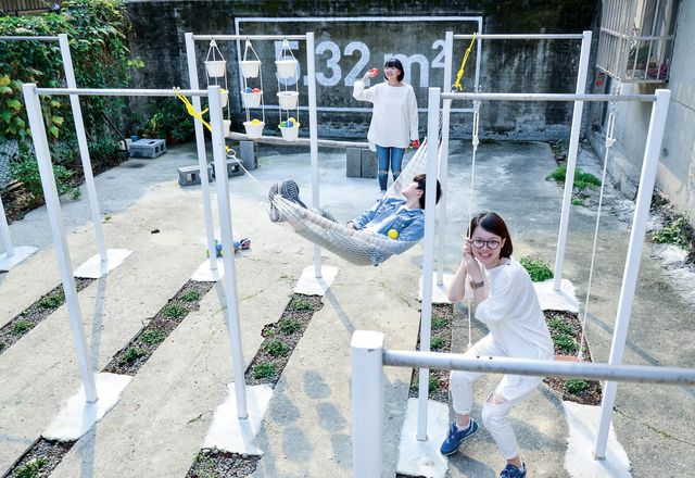 Steel horizontal bars serve as scaffolding for a variety of uses at the ParkUp community gathering site in Taipei, Taiwan designed by Plan b.
