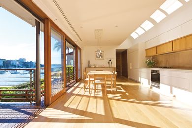 The kitchen and dining area overlooks a harbour beach in Sydney.