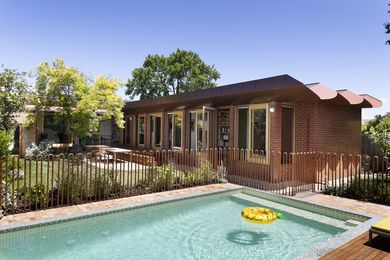 A 1960s-era brick house has been altered and extended to accommodate a family of six.