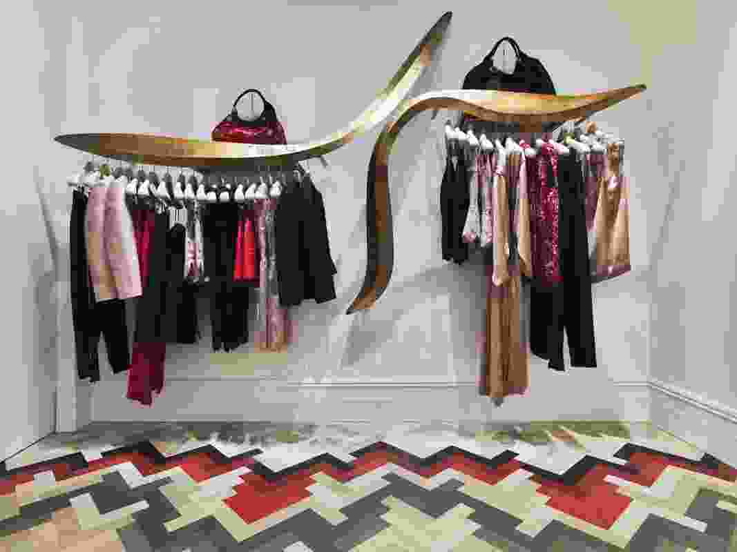 Clothing racks become sculptural wall pieces.