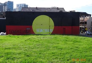 An inscription over the Aboriginal flag on the back of a gym in Redfern, 22 June 2014.