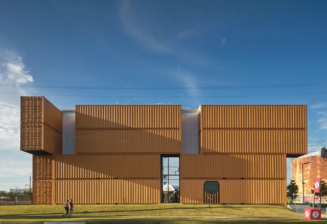 What might have been a rigid grid is animated by the simple gesture of shifting the top two containers across the facade.