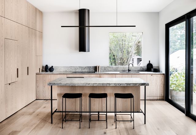 This is a crisp, minimalist kitchen in a house that serves as a holiday retreat for the owners’ family and friends.