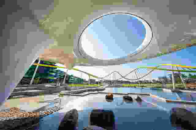 Water cascades through an oculus in the Disc, which offers shade and evaporative cooling, while providing a visual anchor to the Village Heart and main park beyond.