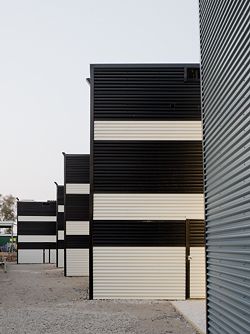 Oblique view along the western edge of the complex, showing the black-and-white pattern in the cladding on the southern walls.