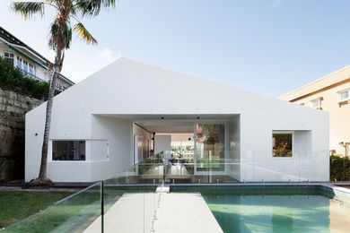 A timber deck inset at the rear expresses the house volume into the yard and pool.