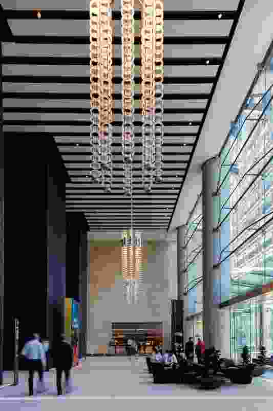 The three-storey lobbies are “heroically scaled” spaces with subtle variations in mosaic colours and glazing tectonics.