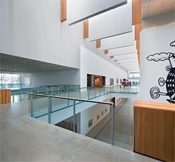 Looking along the pavilion walk on level three. The gallery interior was conceived as a “street” and is ordered by the cruciform pattern of a street intersection. Michael Tuffery’s Povi tau vaga (The challenge), 1999, is seen in the middle of the space.