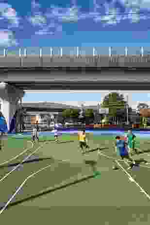 Local residents enjoy a game of soccer on one of the numerous sporting areas nestled beneath the rail line.