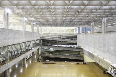 FAU-USP features a vast atrium illuminated from above through a sublime textile of interlocking concrete elements.