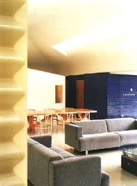 Overview of the living space, with skylight above and the boxes housing study and bedroom beyond.