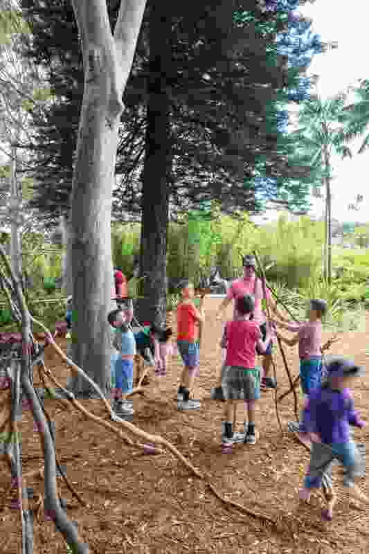 Children craft shelters from branches at the Ian Potter Children’s Wild Play Garden.