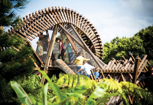 Visitors clamber through the fantastically twisty timber treehouse at the Ian Potter Children’s Wild Play Garden.
