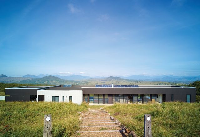 This long and simple house is tucked into the slope, so that on arrival from above, the views are paramount.