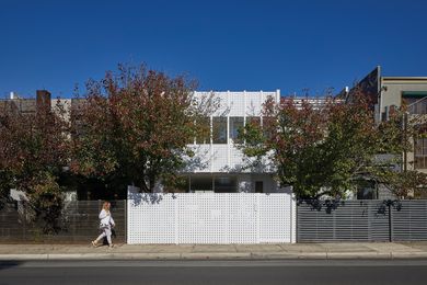 While the house’s scale and form tie in with the street, its new powdercoated aluminium facade glows brightly.